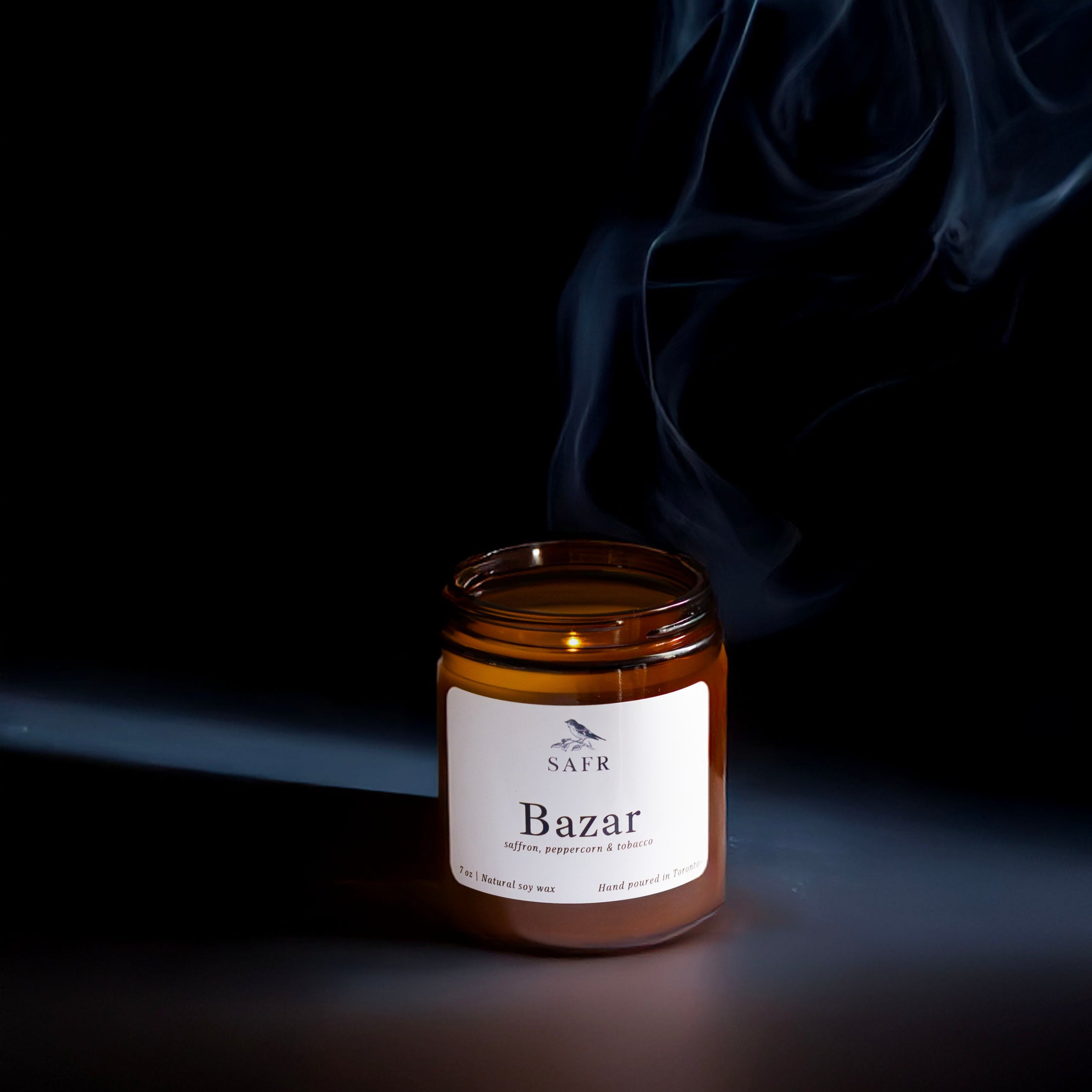 Jar labeled 'Bazar' with smoke against a dark background
